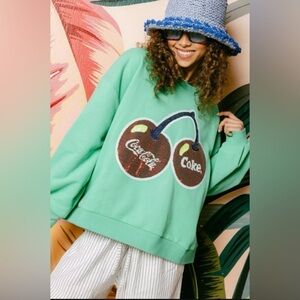 QUEEN OF SPARKLES Coca-Cola Green Cherry Graphic Sweatshirt